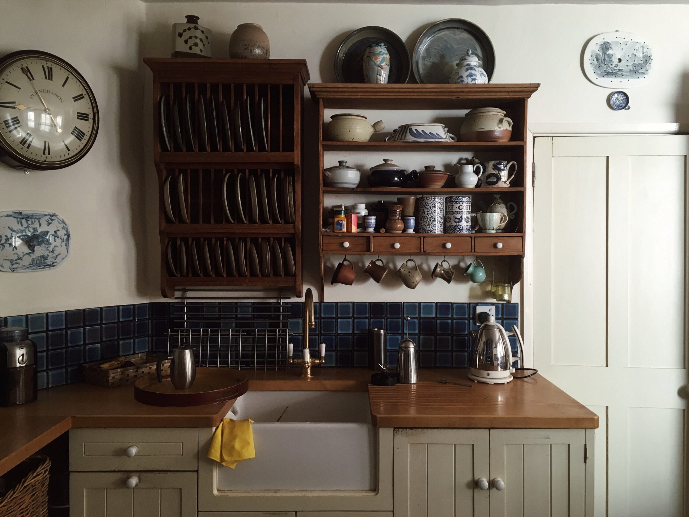 Kitchen cupboard and rack with dinnerware arranged
